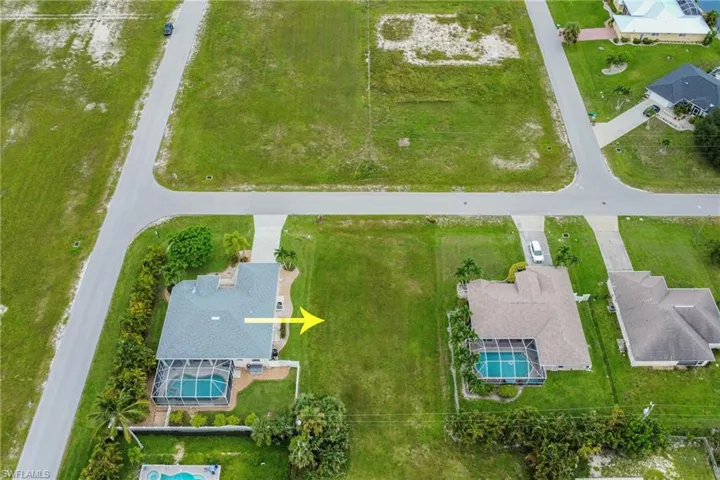 Aerial perspective of suburban area featuring a pool area