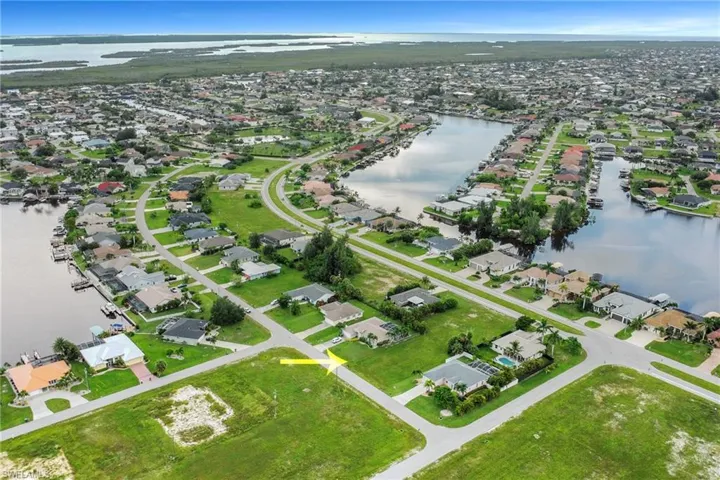 Aerial view of property's location with nearby suburban area and a nearby body of water