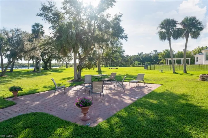 Paver walkway leads to this outdoor paito perfect for a garden party and evenings by the fire.