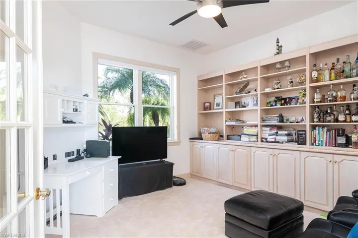 Spacious office/Den with double french doors off of the main living area.  Built in cabinets and book shelves complete the space.