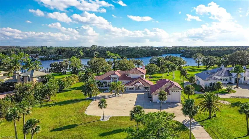Aerial view of the property facing south towards the Caloosahatchee.  Lots of open space and expansive circular driveway.  All the comforts of home in this magnificent SW Florida Country estate on 3.88 Acres of Riverfront.