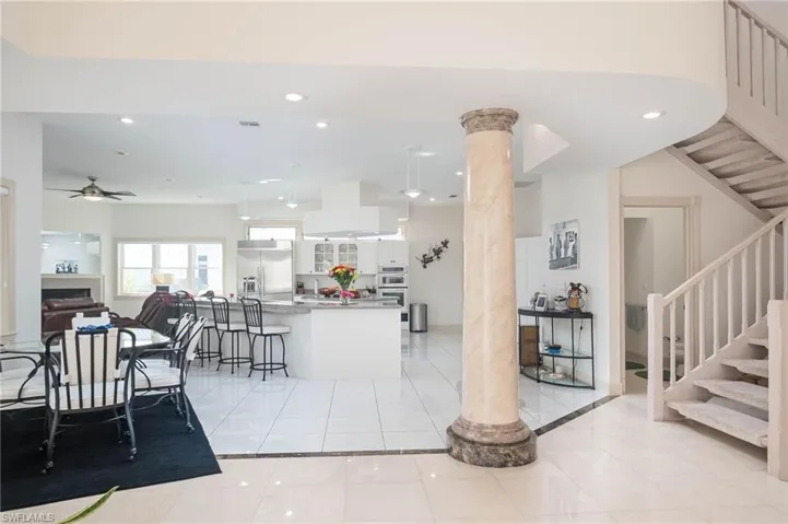 View of dining area, kitchen, family room and half bath to the right by the stairs.  Gorgeous Italian Marble floors throughout.