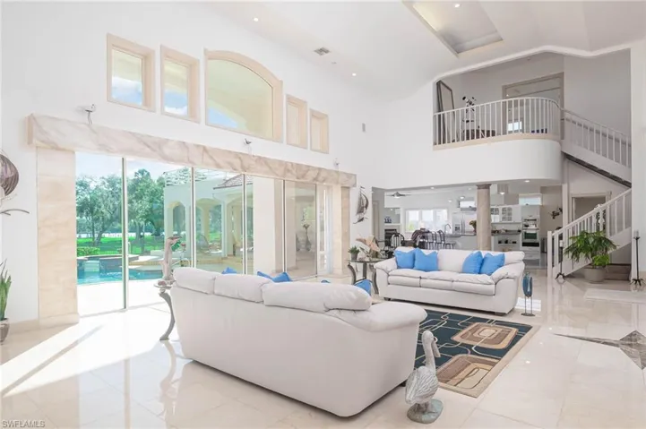 View from living room facing staircase to master bedroom suite, kitchen and family room