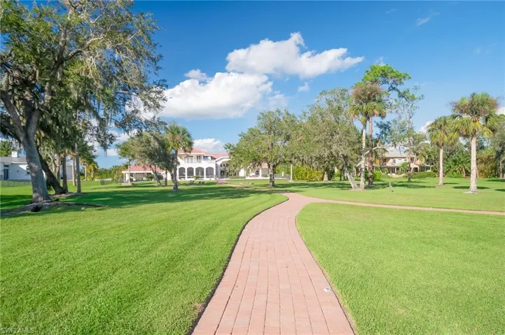 Lovely paver walkway meanders through the property from the home to the outdoor patio, firepit, tiki hut and boat dock & lifts.