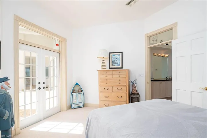 Second guest room with french doors leading to the lanai and big walk in closet.
