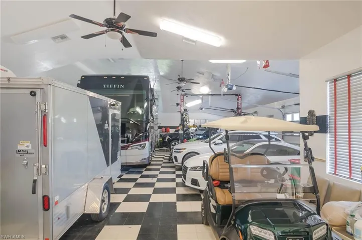 Air conditioned garage with checkerboard flooring, full bath and workshop.  Enough space for all your toys and then some.  Easily accommodates 6+ cars.