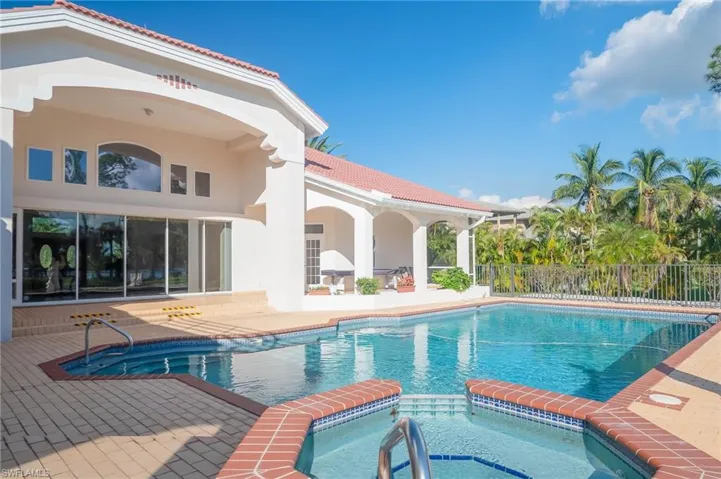 Custom lap pool with built in spa with waterfall.  Newer pool equipment including heater and salt water system. Plent of room for sunbathing in the warm Florida sun.