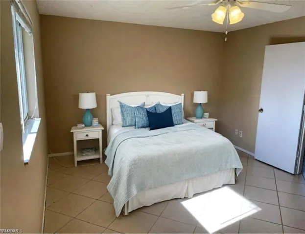 Tiled bedroom with ceiling fan