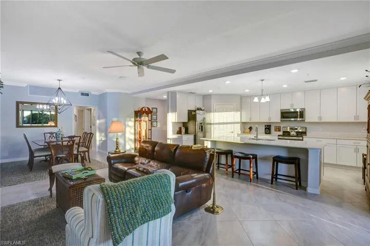 Living room featuring hanging lights and a ceiling fan