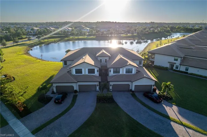 Aerial view of property and surrounding area featuring a large body of water