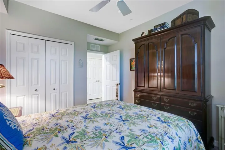 Bedroom featuring ceiling fan, a closet, and radiator heating unit