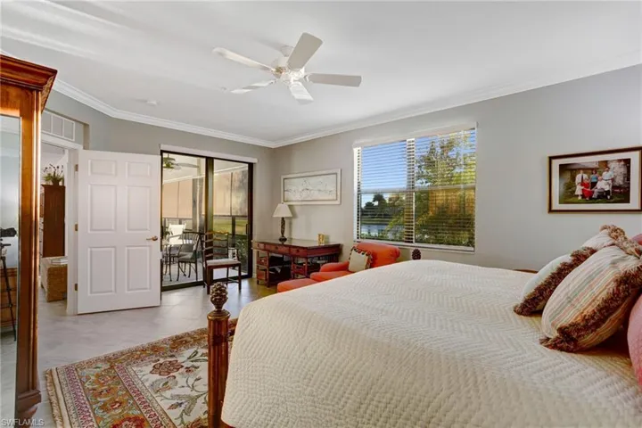 Bedroom with access to exterior, ornamental molding, and a ceiling fan