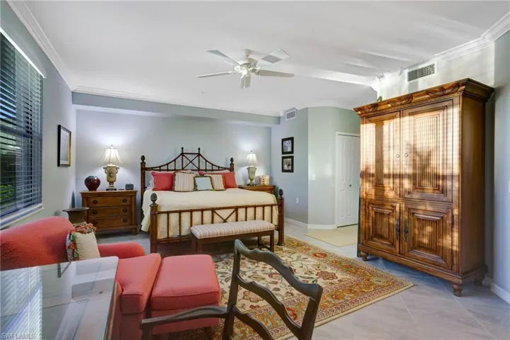 Bedroom featuring crown molding, ceiling fan, and light tile patterned floors