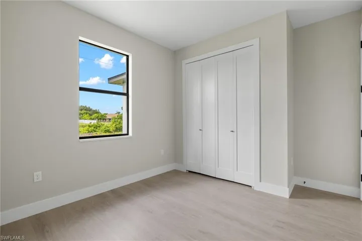 Unfurnished bedroom with a closet and light hardwood / wood-style floors
