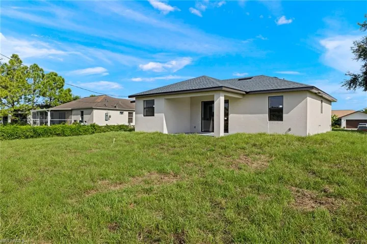 Rear view of house with a lawn