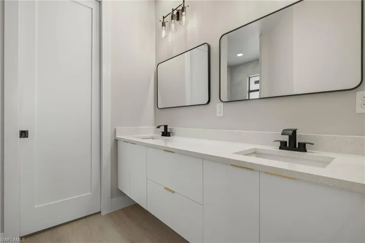Bathroom featuring vanity and wood-type flooring