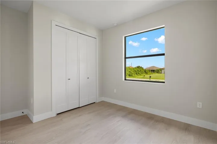 Unfurnished bedroom with a closet and light hardwood / wood-style floors