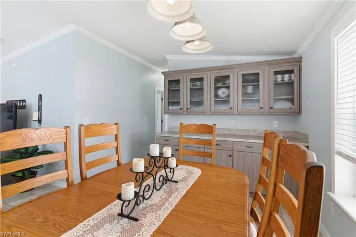 Dining room featuring ornamental molding and light wood-style floors