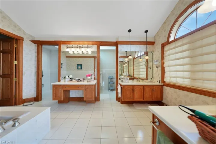 Bathroom with plus walk in shower, tile patterned flooring, and vanity