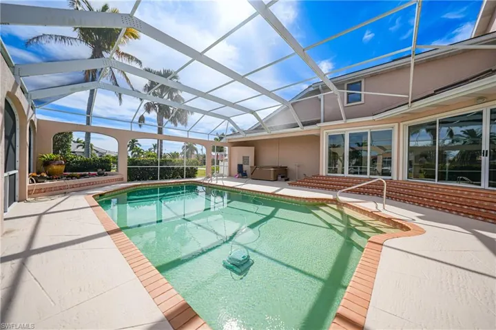 View of swimming pool featuring a lanai and a patio area