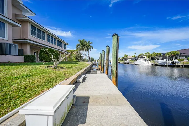 View of dock featuring a water view and a yard