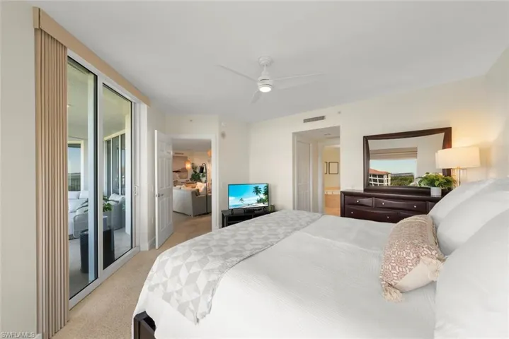 Bedroom featuring light carpet, access to outside, and ceiling fan