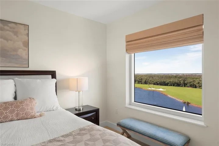 Bedroom with a water view and baseboards