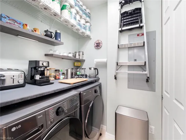 Laundry area with washer and dryer and electric panel