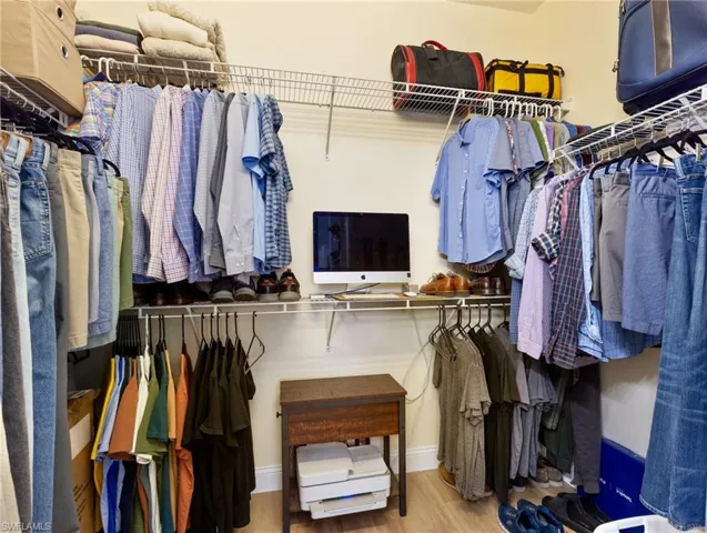 Walk in closet featuring light wood-style floors