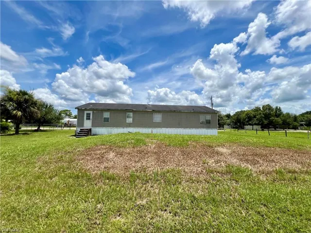 View of side of property featuring a lawn