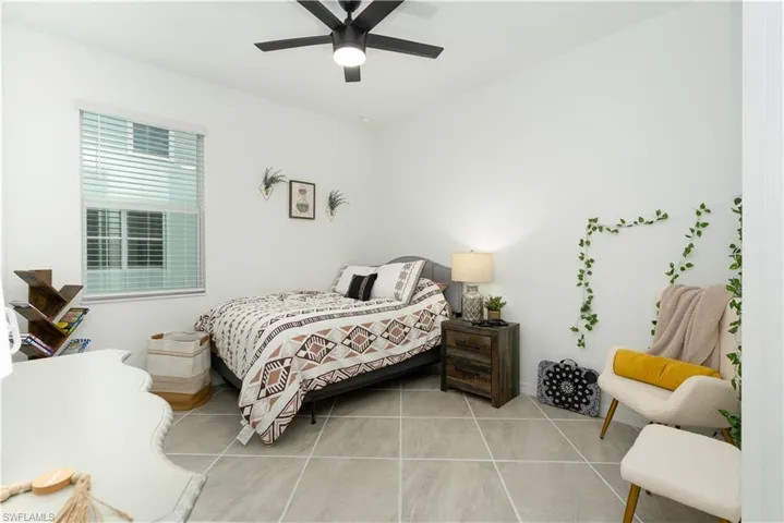 Guest Bedroom with tile flooring and ceiling fan