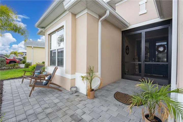 View of exterior entry featuring the added paver patio adding additional curb appeal and adding another great living space to this home.