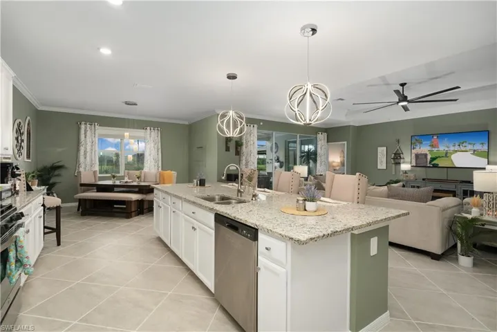 Kitchen featuring white cabinets, an in island sink, and GE stainless steel appliances