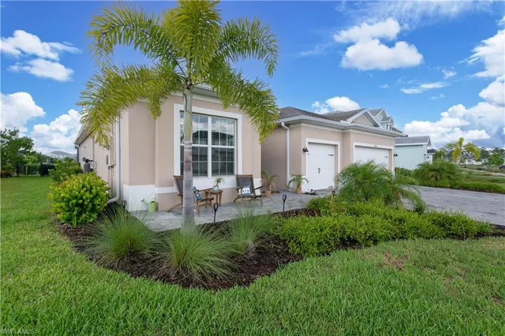 View of front facade featuring a front lawn and a garage