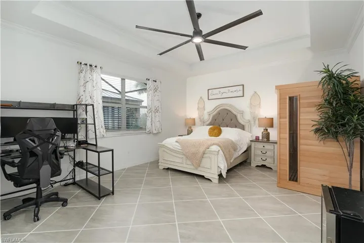 Primary bedroom, tile flooring, and sliding doors to the lanai