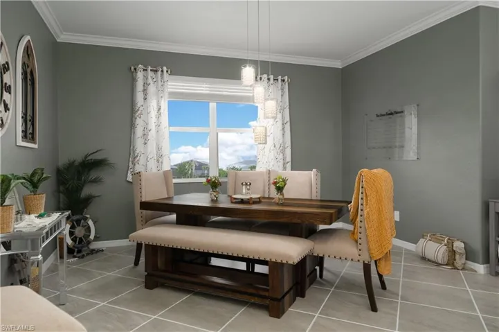 Spacious tiled dining space featuring crown molding, window overlooks the pool area