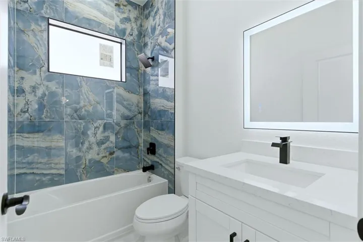 Bathroom with vanity and tub / shower combination