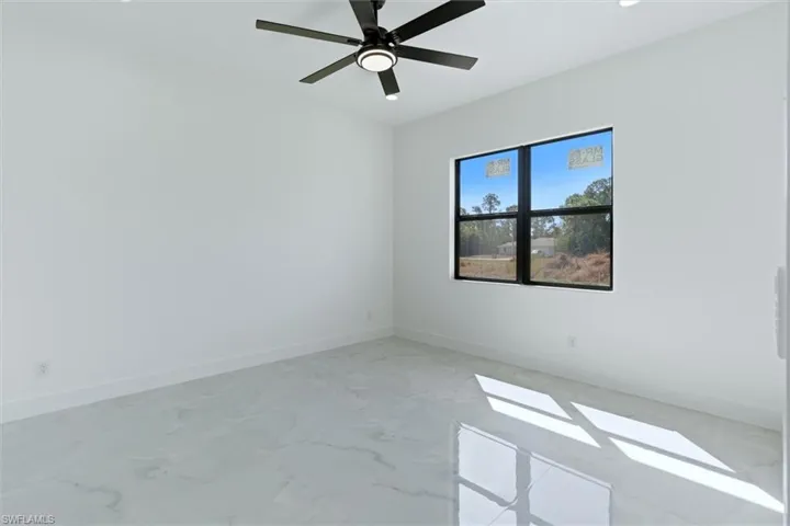 Empty room with baseboards and ceiling fan