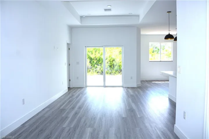 Unfurnished Living Room with back sliding doors for plenty of natural light.