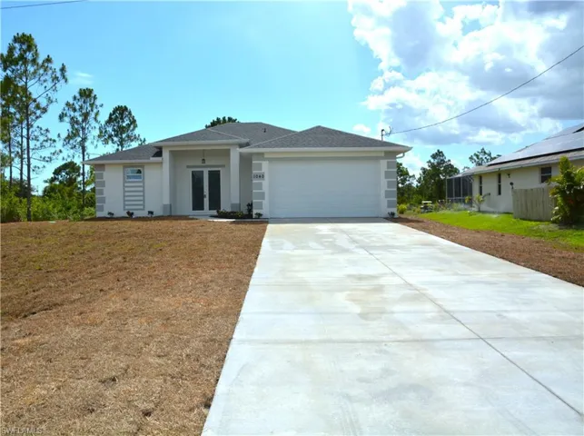 View of front of home with a garage and Concrete Driveway.