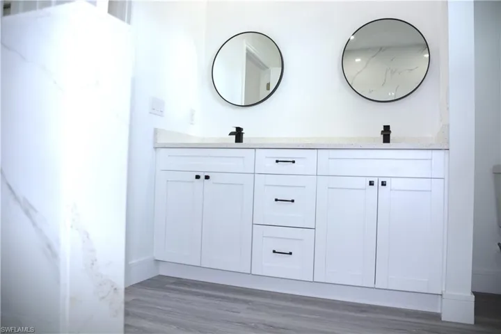 Bathroom with dual wood vanity.