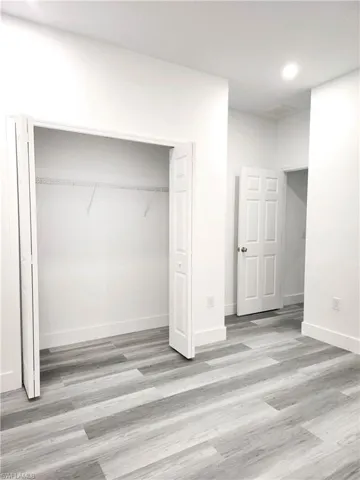 Unfurnished bedroom with a closet and light hardwood / Water Prove Laminated-style floors.