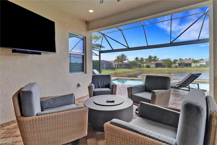 View of patio / terrace with a water view, an outdoor living space, and a lanai