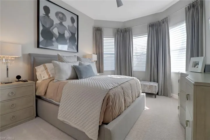 Carpeted bedroom with ceiling fan
