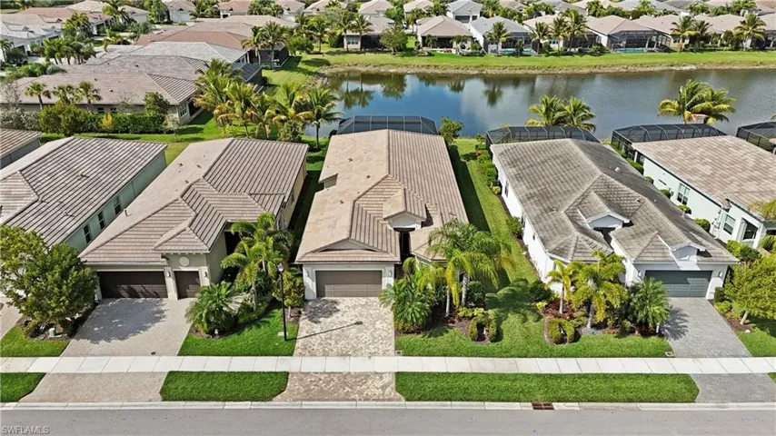 Birds eye view of property with a water view