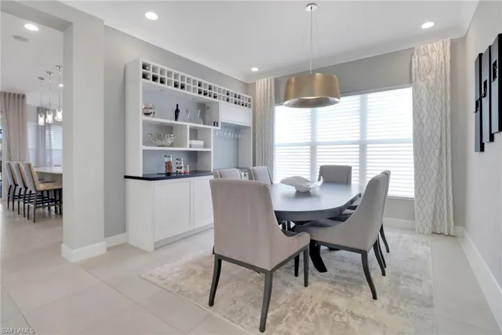 Dining space with light tile patterned floors