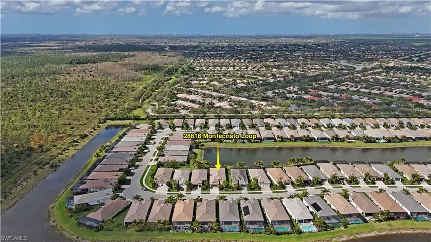 Birds eye view of property with a water view