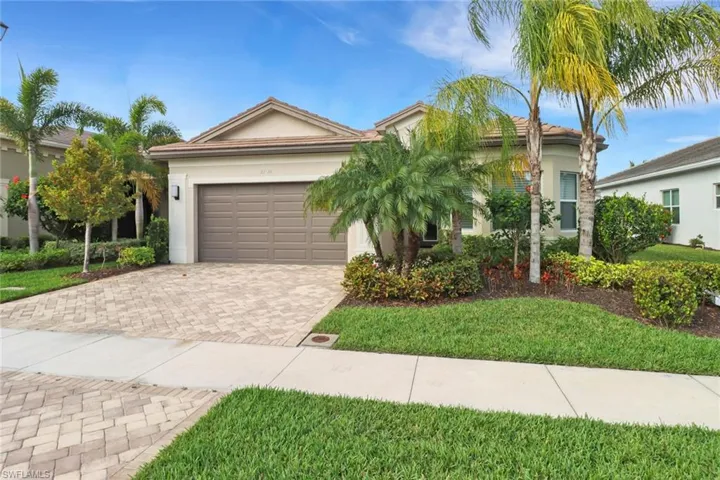 View of front of property featuring a garage and a front yard