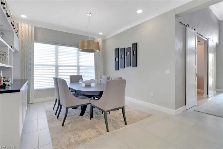 Dining space with light tile patterned floors