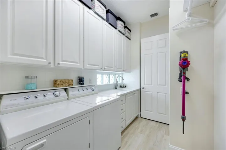 Dedicated laundry area featuring a built-in sink.